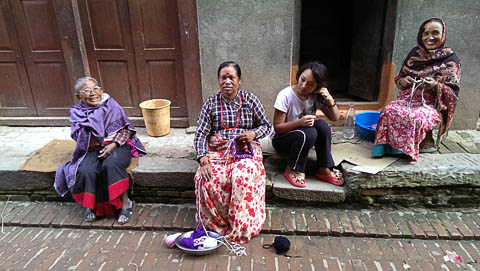 Knitting and chatting on the street in Bhaktapur