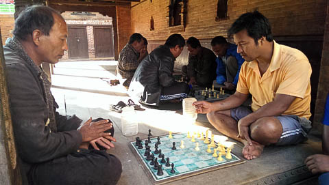 Playing chess in one of the streetside shelters in Bhaktapur